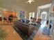 Open-concept living room featuring hardwood floors, fireplace and seamless access to kitchen and dining area at 11646 Hidden Forest Ln, Davidson, NC 28036