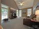 Cozy living room with vaulted ceiling, large windows, carpet flooring and comfortable seating at 11646 Hidden Forest Ln, Davidson, NC 28036