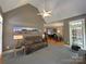 Spacious living room with vaulted ceiling, lots of natural light and plush sofa at 11646 Hidden Forest Ln, Davidson, NC 28036