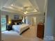 Spacious main bedroom features a tray ceiling, plush carpet, and an ensuite bathroom at 11646 Hidden Forest Ln, Davidson, NC 28036