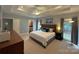 Main bedroom with a tray ceiling, carpeted floor, and generous natural light from two windows at 11646 Hidden Forest Ln, Davidson, NC 28036