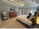 Large main bedroom boasts a tray ceiling, soft carpet, and ample natural light at 11646 Hidden Forest Ln, Davidson, NC 28036