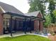 Charming covered patio featuring string lights and ample seating area, perfect for outdoor relaxation at 11646 Hidden Forest Ln, Davidson, NC 28036