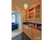 Stylish wet bar features custom cabinetry, granite countertop, and glass shelving at 11646 Hidden Forest Ln, Davidson, NC 28036