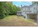 A spacious backyard featuring a screened-in porch, a detached carport, and lush greenery for outdoor enjoyment at 119 Foote St, Chester, SC 29706