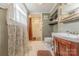 A charming bathroom with a shower, decorative shelves, and a wooden vanity, all illuminated by soft, natural light at 119 Foote St, Chester, SC 29706