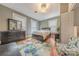 Comfortable bedroom with hardwood floors, a dresser, and three bright windows at 119 Foote St, Chester, SC 29706