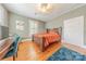 Bedroom with hardwood floors, a bed, a desk, and three windows for ample natural light at 119 Foote St, Chester, SC 29706