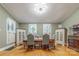 Light-filled dining room has hardwood flooring, two built-in cabinets, and table with six chairs at 119 Foote St, Chester, SC 29706