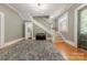 Welcoming foyer featuring hardwood floors, staircase, and stylish lighting, offering a glimpse into the home's interior at 119 Foote St, Chester, SC 29706