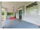 Inviting front porch with traditional columns, a cozy rug, and ample space for enjoying the outdoors at 119 Foote St, Chester, SC 29706