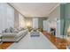 Cozy living room with a decorative fireplace, plush seating, and plenty of natural light from shuttered windows at 119 Foote St, Chester, SC 29706