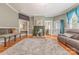 Spacious living room with fireplace and hardwood flooring; features a large gray area rug at 119 Foote St, Chester, SC 29706