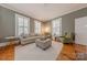 Bright living room featuring multiple shuttered windows, a neutral color scheme, and comfortable, stylish furniture at 119 Foote St, Chester, SC 29706