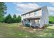 Backyard featuring large grassy area and the rear of the beige home at 11922 Kimberfield Rd, Matthews, NC 28105