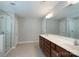 Spacious bathroom featuring double vanity sinks and a glass-enclosed shower at 11922 Kimberfield Rd, Matthews, NC 28105