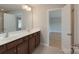 Bright bathroom features a double sink vanity, updated fixtures, and tile floors at 11922 Kimberfield Rd, Matthews, NC 28105