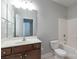 Clean bathroom featuring a single vanity, toilet, and shower-tub combination at 11922 Kimberfield Rd, Matthews, NC 28105