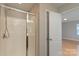 Bathroom featuring a glass shower door and a door that leads to another room at 11922 Kimberfield Rd, Matthews, NC 28105
