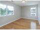 This bedroom features hardwood floors and plenty of natural light from two large windows at 11922 Kimberfield Rd, Matthews, NC 28105