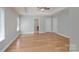 The spacious bedroom boasts a tray ceiling, fan, hardwood floors, and many windows for natural light at 11922 Kimberfield Rd, Matthews, NC 28105