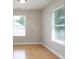 Cozy bedroom with plenty of natural light from two large windows and hardwood floors at 11922 Kimberfield Rd, Matthews, NC 28105