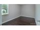 Simple bedroom featuring hardwood floors, window, and neutral wall colors at 11922 Kimberfield Rd, Matthews, NC 28105