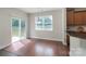 Bright dining area featuring hardwood floors, sliding glass doors, and a modern light fixture at 11922 Kimberfield Rd, Matthews, NC 28105