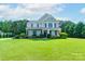 Inviting two-story home featuring a large lawn, well-maintained landscaping, and classic design at 11922 Kimberfield Rd, Matthews, NC 28105