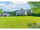 Traditional two-story home with a spacious lawn and mature trees, offering curb appeal at 11922 Kimberfield Rd, Matthews, NC 28105