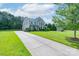 Beautiful two-story home with a long driveway, lush green lawn, and mature trees at 11922 Kimberfield Rd, Matthews, NC 28105