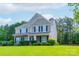 Charming two-story home with a well-manicured lawn, mature trees, and beautiful landscaping at 11922 Kimberfield Rd, Matthews, NC 28105