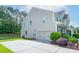 Beige two-story home with an attached two-car garage, manicured landscaping, and a paved driveway at 11922 Kimberfield Rd, Matthews, NC 28105