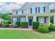 Charming home entrance with manicured hedges, stone accents, and a welcoming front door at 11922 Kimberfield Rd, Matthews, NC 28105