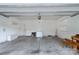 Empty two car garage with white walls, peg boards, and overhead storage at 11922 Kimberfield Rd, Matthews, NC 28105