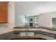 Kitchen with stainless steel sink and granite countertops open to the living room with a fireplace at 11922 Kimberfield Rd, Matthews, NC 28105