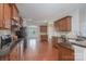 Functional kitchen with granite countertops, wooden cabinets, and stainless steel appliances at 11922 Kimberfield Rd, Matthews, NC 28105