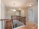 Second floor landing with wood floors, railing, and natural light from nearby windows at 11922 Kimberfield Rd, Matthews, NC 28105