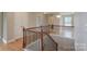 Bright upper landing with wood floors and decorative railing overlooking the entry at 11922 Kimberfield Rd, Matthews, NC 28105