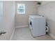 Bright laundry room features modern washer and dryer, tile floors, and wire shelving at 11922 Kimberfield Rd, Matthews, NC 28105