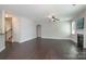 Open living room with hardwood floors, fireplace, and staircase leading to the upper level at 11922 Kimberfield Rd, Matthews, NC 28105