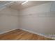 Walk-in closet with hardwood floors, wire shelving, and ample storage space at 11922 Kimberfield Rd, Matthews, NC 28105