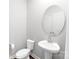 Well-lit bathroom featuring a modern sink, mirror and toilet at 11965 Hambright Rd, Huntersville, NC 28078