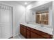 Bright bathroom featuring double sinks, granite countertop, framed mirror and tiled shower at 11965 Hambright Rd, Huntersville, NC 28078