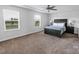 Bedroom with a large bed, side tables, and two windows at 11965 Hambright Rd, Huntersville, NC 28078