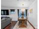 Dining room features a chandelier, wood table, rug, and a large TV at 11965 Hambright Rd, Huntersville, NC 28078