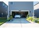 Attached garage with electric car, clean epoxy flooring, and garden landscaping at 11965 Hambright Rd, Huntersville, NC 28078