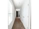 Clean, carpeted hallway with white walls, doors, trim, and natural light through large window at 11965 Hambright Rd, Huntersville, NC 28078
