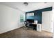 Office with navy accent wall, carpet, desk, and white shelving at 11965 Hambright Rd, Huntersville, NC 28078