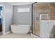 Bright bathroom with soaking tub, separate glass shower, and modern finishes at 12205 Hollinhope Dr, Charlotte, NC 28278